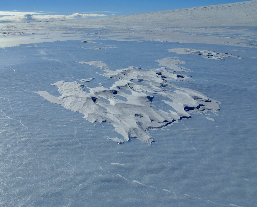 Sastrugi, windblown ice structures seemingly as hard as cement which pound your sledges until any load marginally secured spalls off and is left behind.