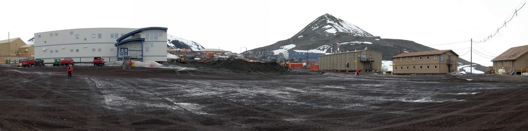 Field of mud; an open area to gather machinery between the buildings