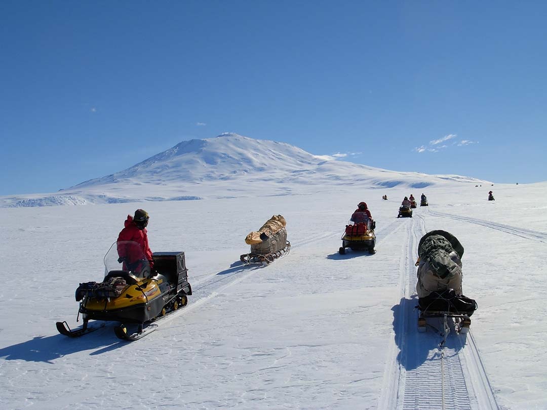 Traveling overland in Antarctica via mechanized dog sledges. Snowmobiles pull our sledges instead of dogs allow us to carry all the necessary gear.