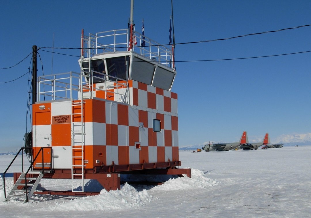 We are preparing to launch in our C-130 Cargo plane seen parked beyond the flight control tower at Willy Field in McMurdo Station.