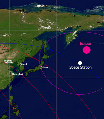 Map view showing the location of space station (white dot), its orbit track (blue line; next three orbits red lines), visual horizon (purple circle), and the eclipse shadow (pink dot) during the encounter east of Kamchatka.