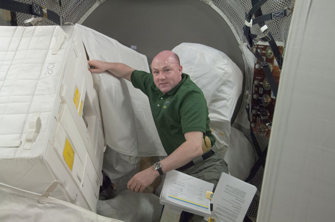 A space equivalent of a bucket brigade; passing bags the size of refrigerators crew-to-crew.