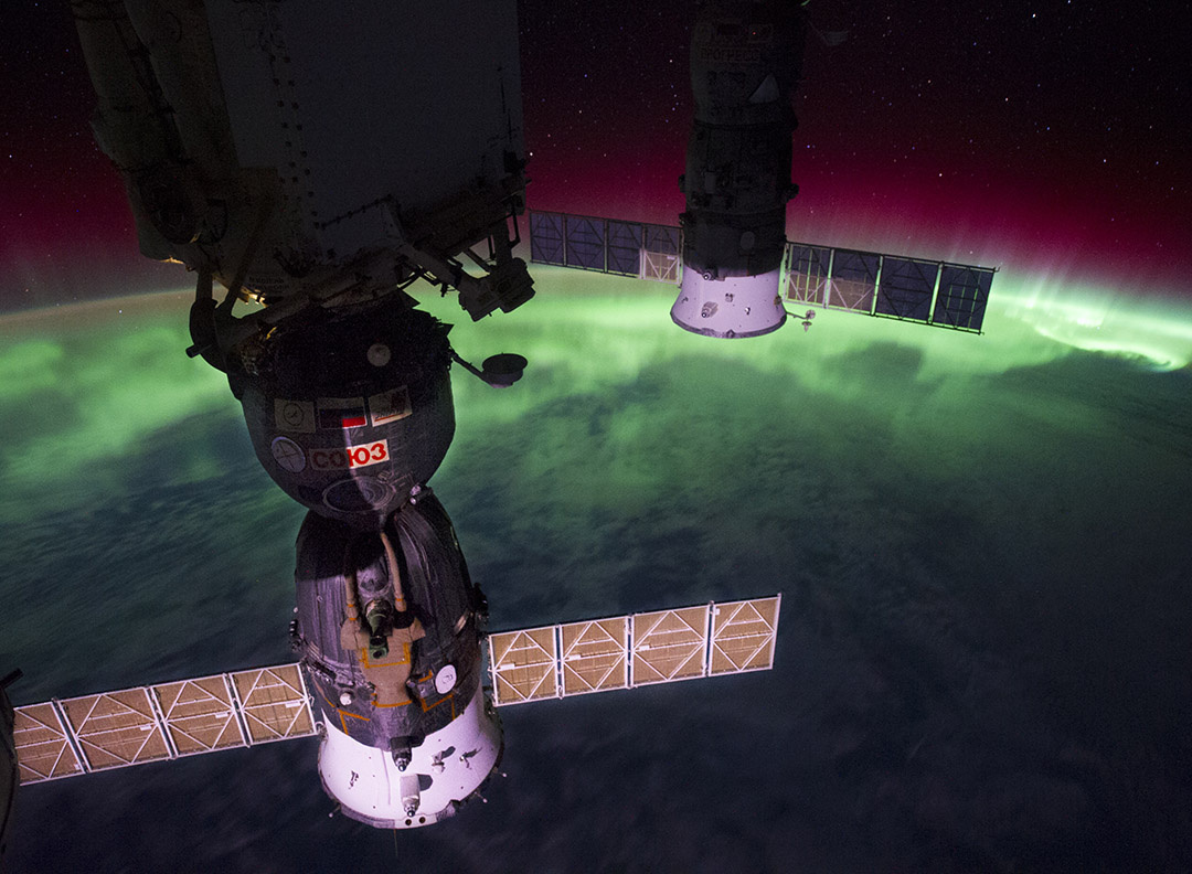 Same window, same planet, but a different way of viewing; reds and greens from aurora